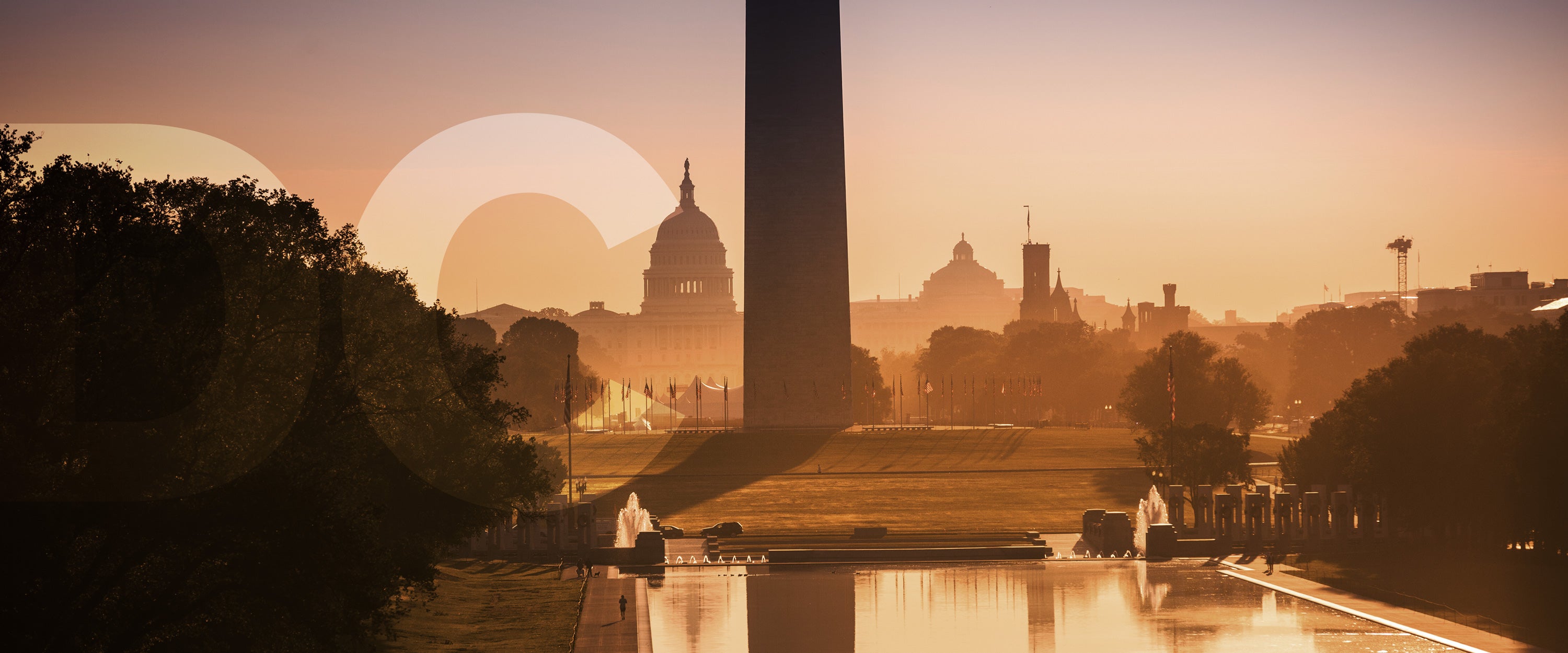 View of the Capitol Building behind the Washington Monument with golden light