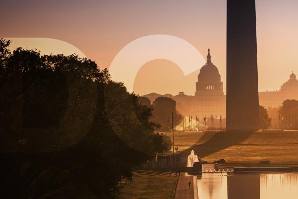 View of the Capitol Building behind the Washington Monument with golden light