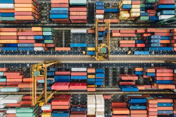 Birds-eye view of a cargo ship with multiple cargo shipments in red and blue colors.