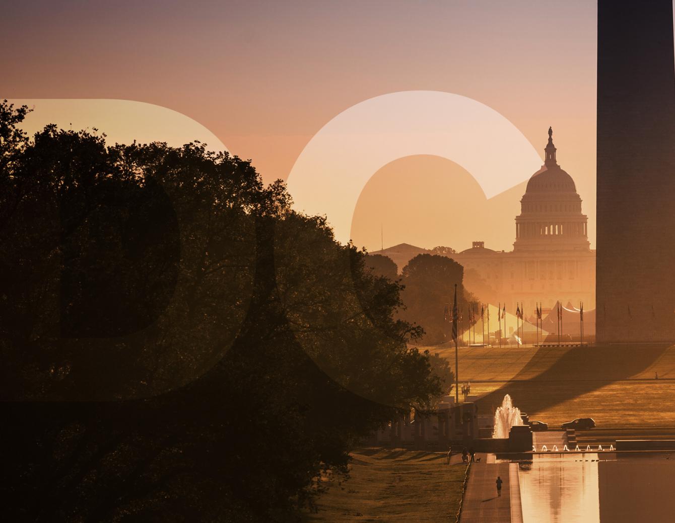 View of the Capitol Building behind the Washington Monument with golden light