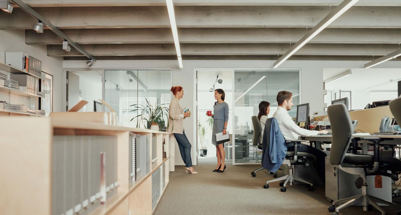 Two women talking in an open office