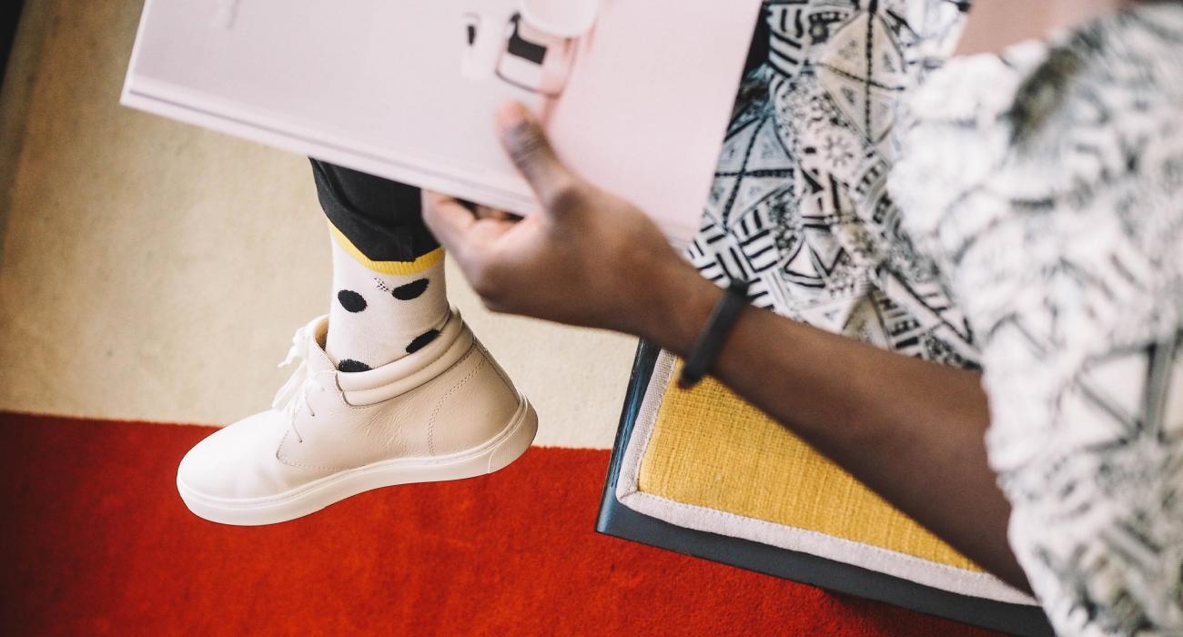 Overhead view of stylish young man reading a magazing