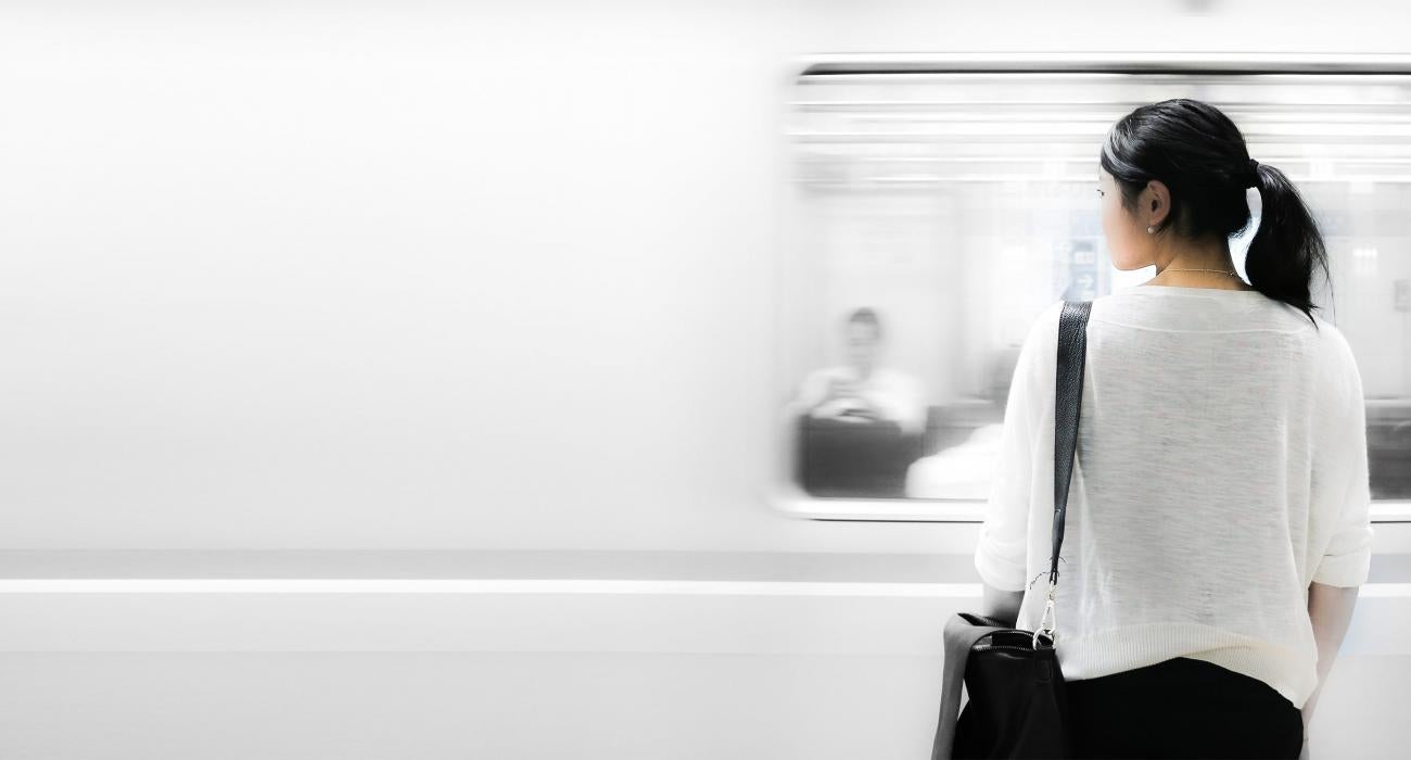 Woman waiting as subway speeds by