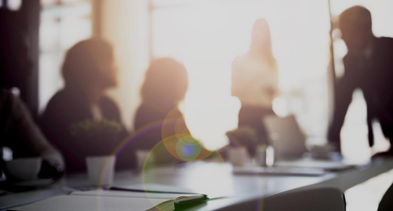 Silhouette of people working at a conference table