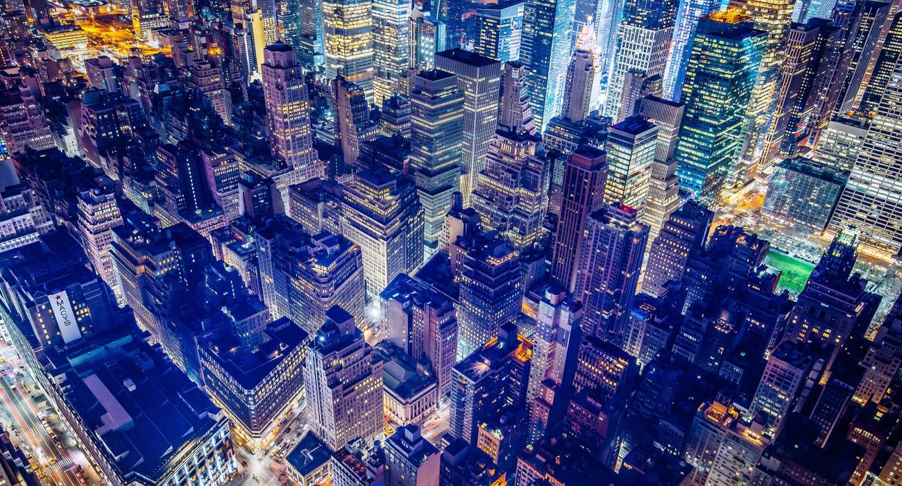 Nighttime sweeping aerial shot of NYC