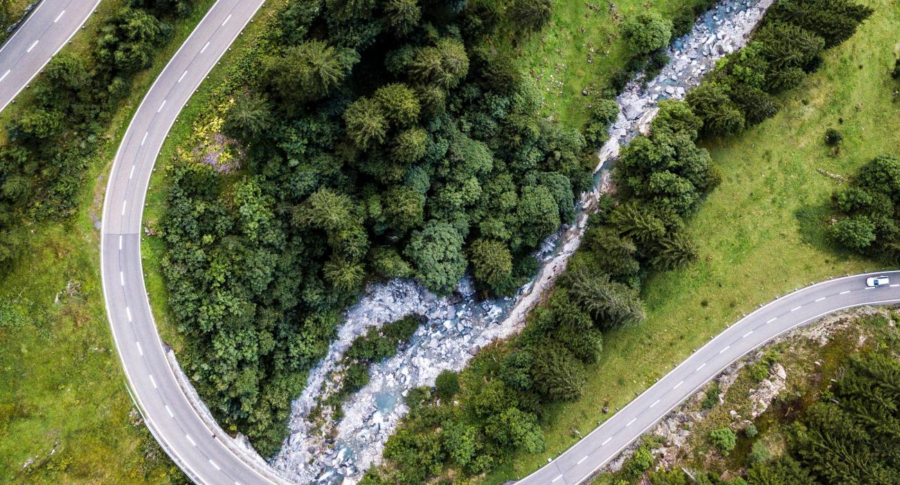 Aerial view of a car on a long, winding road