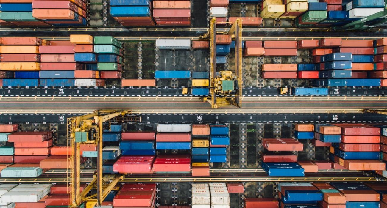 Birds-eye view of a cargo ship with multiple cargo shipments in red and blue colors.