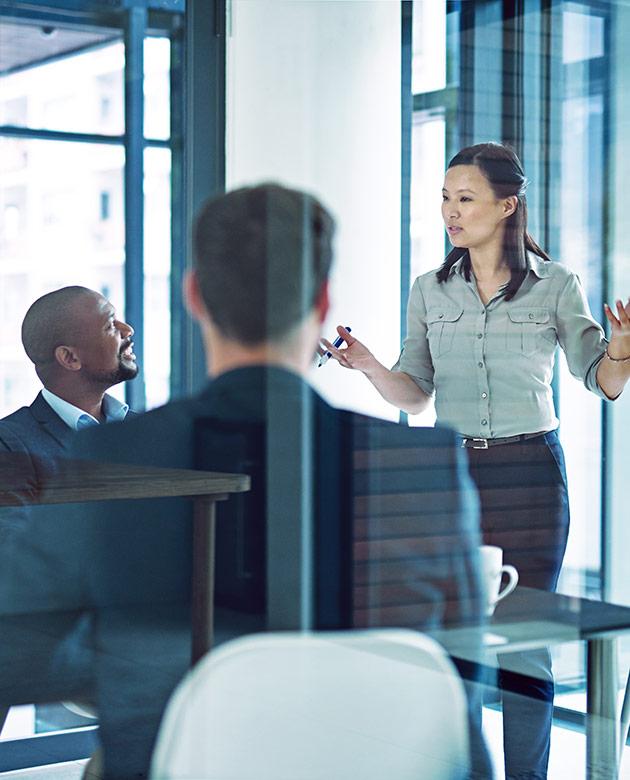 Woman presenting to team in stylish office